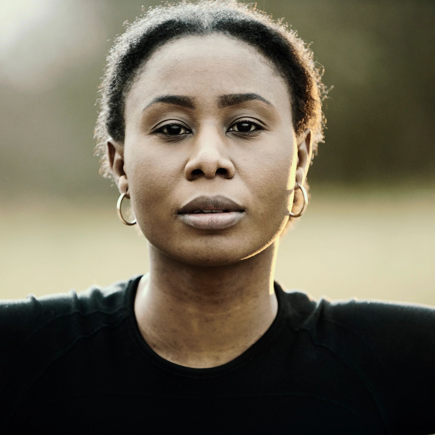 Close-up portrait of an athletic woman outdoors