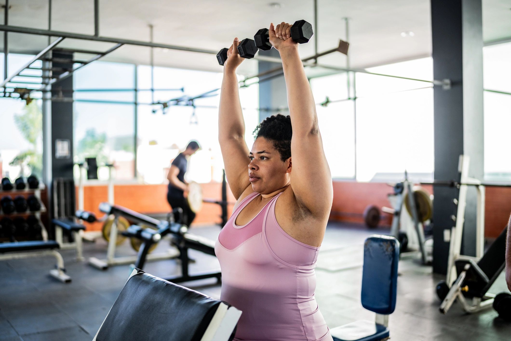 Woman performing a dumbbell shoulder exercise