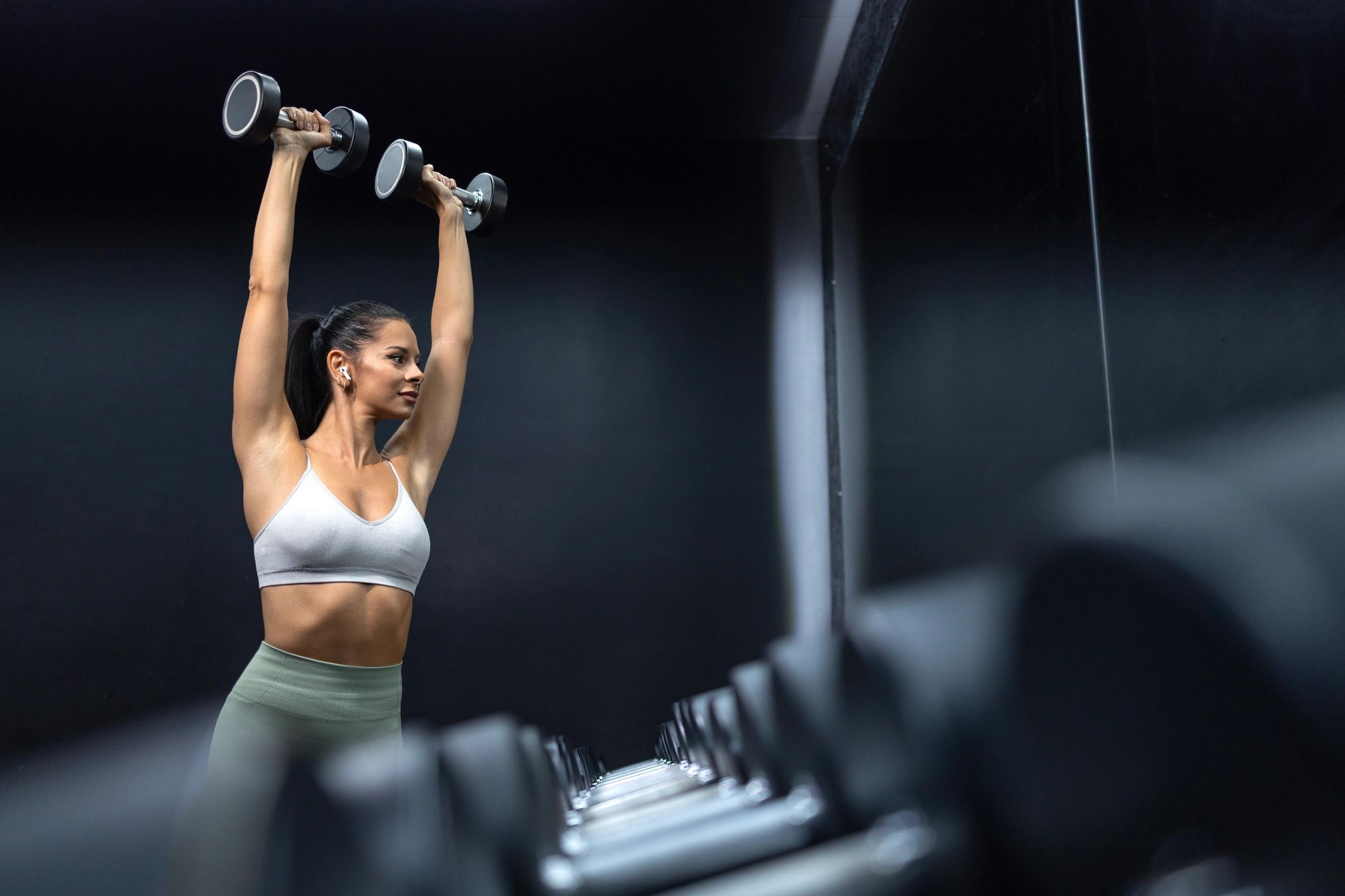 Female athlete lifting weights in a gym
